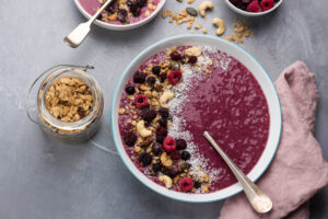 Smoothie Bowl mit Himbeeren, Granola und Kokosflocken